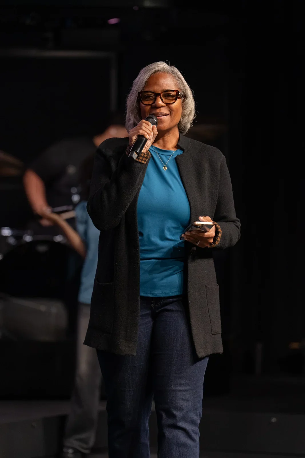 Speaker addressing the audience with a microphone